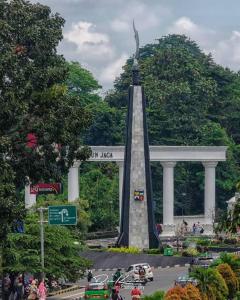 a monument with a statue in the middle of a street at Yayah Hostel in Bogor