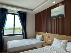 Postel nebo postele na pokoji v ubytování Ngọc Anh Hotel