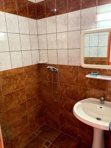 a bathroom with a shower and a sink at Hotel Nalba Jupiter in Jupiter