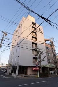 a tall building on the corner of a street at Hotel New Moustache in Shizuoka