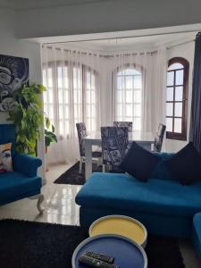 a living room with a blue couch and a table at cozy 2 bedroom apartment in Sharm El Sheikh