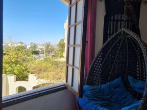 a swing in a window with a view of a street at cozy 2 bedroom apartment in Sharm El Sheikh