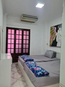 a room with two beds and a painting on the wall at cozy 2 bedroom apartment in Sharm El Sheikh