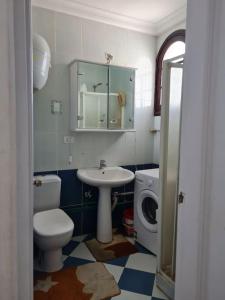 a bathroom with a toilet a sink and a mirror at cozy 2 bedroom apartment in Sharm El Sheikh