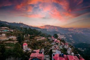 an aerial view of a city at sunset at Meraki shimla in Shimla