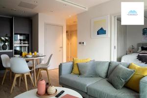 a living room with a couch and a dining room at Stunning 1 Bed apartment at Kings Cross-St Pancras By City Apartments UK Short Lets Serviced Accommodation in London
