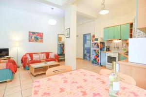 a kitchen and living room with a table and a couch at Kaminaki Dora in Nisaki