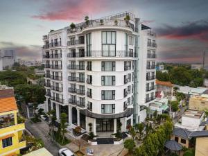 a white building with a balcony on top of it at SQ Thao Dien in Ho Chi Minh City