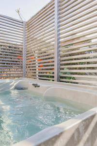 a hot tub in front of a large building at Vakantiehuis Juliette in Diksmuide