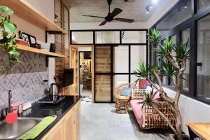 a kitchen with plants and a ceiling fan at URI HOUSE, 1-2 BR tourism apt, 5' walk Dragon Bridge in Danang