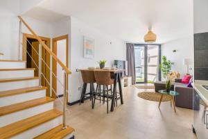 a living room with a staircase and a table at Casa Corralito - 2 bedrooms, rooftop sea view in Cotillo