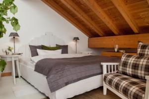 a bedroom with a large bed and a wooden ceiling at Bergesgrün in Oberstdorf +77 photos