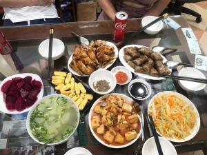 a table with many different types of food on it at Green Riders House in Cao Bằng