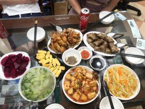 a table with many different types of food on it at Green Riders House - Motorbike Rental & Tours in Cao Bằng