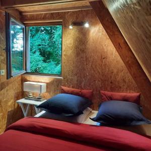 a bedroom with two beds and a window at La Petite Motte in Ceton