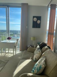 a living room with a couch and a table with a view at Apartment 7 in Milton Keynes