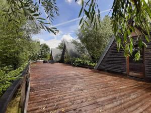 a wooden boardwalk leading to a house at La Petite Motte in Ceton
