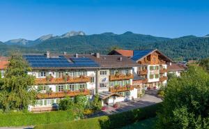 a hotel with solar panels on its roof at Alpenhof Krün in Krün