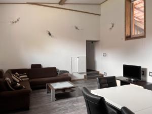 a living room with a couch and a table at Dill Apartments Gadenstedt in Ilsede