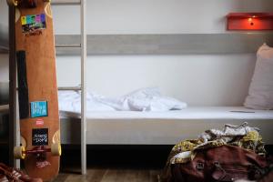 a bedroom with a bunk bed and a skateboard at Pfefferbett Hostel in Berlin