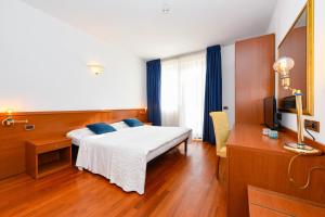 Postel nebo postele na pokoji v ubytování Hotel New Genziana