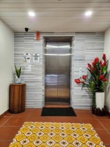 a lobby with a glass door and a walk in shower at Uptown Eco Hotel in Kuala Terengganu