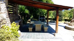 a picnic shelter with benches in a park at Corredoira in Viveiro