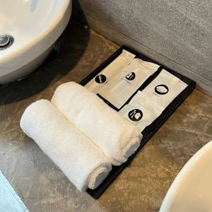 a white towel sitting on the floor next to a sink at Chantara Cottage in Kampung Mawar +9 photos