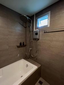a bathroom with a bath tub and a window at Greenspace Living in Ban Tha Phae +34 photos