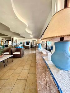 a lobby of a hotel with couches and tables at Hotel Giorgetti Orange in Bellaria-Igea Marina