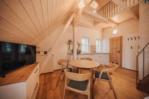 a kitchen and dining room with a table and chairs at Apartman s výhledem in Štramberk