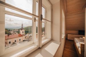 a room with a window with a view of a church at Apartman s výhledem in Štramberk