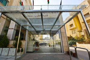 an entrance to a building with a glass roof at Al Thuraya Hotel in Amman