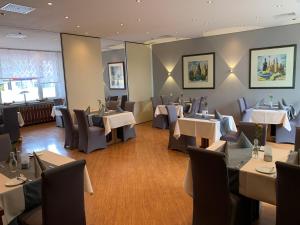 a restaurant with tables and chairs in a room at Ziegenbruch´s Gastronomie in Spenge