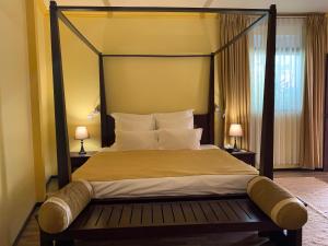 a bedroom with a large bed and two lamps at Sala Boutique Hotel in Male City