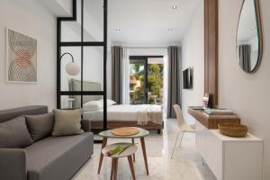 a living room with a couch and a bedroom at CubeStudio21 in Kallithea Halkidikis