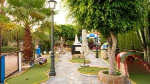 a park with a playground with a slide and a play area at Casa Steven in Torrevieja