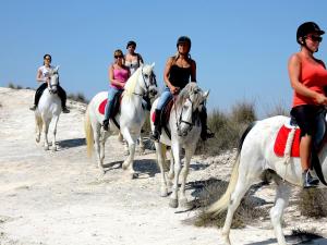 a group of people riding horses on the beach at Casa Steven in Torrevieja