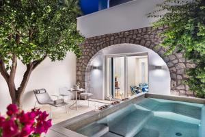 a swimming pool in the middle of a house at Pazziella Garden & Suites in Capri