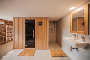 a bathroom with a shower and a sink at Apartman s výhledem in Štramberk