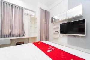 a bedroom with a bed and a flat screen tv at RedLiving Apartemen Vivo Yogyakarta - WM Property in Yogyakarta