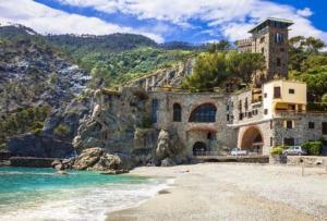 een gebouw op een strand naast het water bij ELI&FRA2 in La Spezia