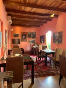 a dining room with tables and chairs and pink walls at Sala Boutique Hotel in Male City