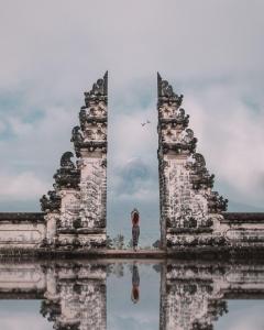 a person standing in the middle of a building at AlamGangga Villas Tirta Gangga in Tirtagangga