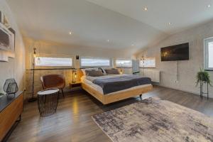 a bedroom with a bed and a couch and a tv at Chalet Young & Fun in Freyung