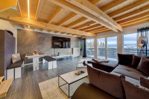 a living room with a couch and a table at Chalet Young & Fun in Freyung