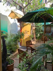 a patio with a table and chairs and an umbrella at Sala Boutique Hotel in Male City
