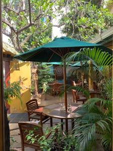 a table and chairs with an umbrella on a patio at Sala Boutique Hotel in Male City