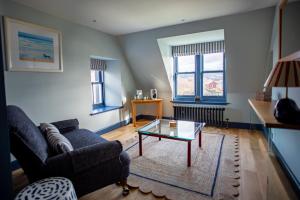 a living room with a couch and a coffee table at The Albannach in Lochinver