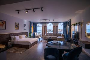 a hotel room with a bed and a living room at El Gouna Elite Villa's & Apartment's Private Residence with Sea & Garden View's - Hurghada in Hurghada